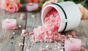 Spa with pink salt, roses and candles, selective focus