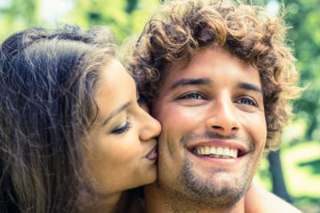 Cute couple relaxing on park bench