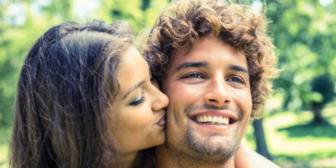 Cute couple relaxing on park bench