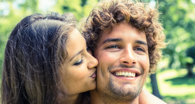 Cute couple relaxing on park bench